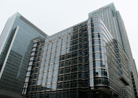 Low angle view of modern glass skyscrapers in an urban setting.