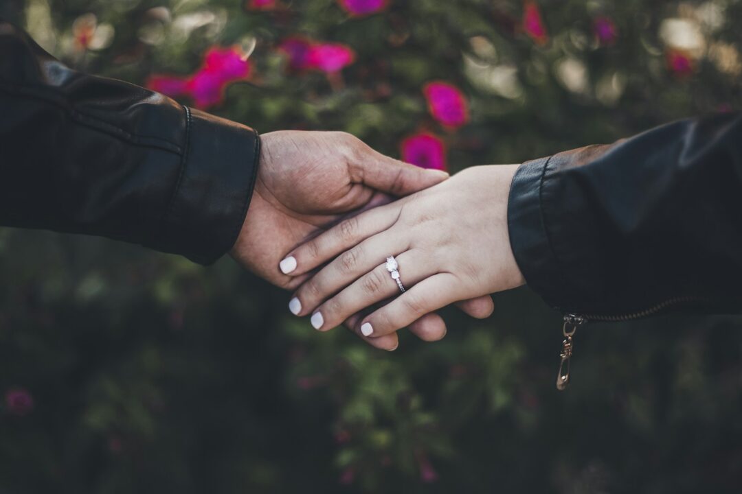 person in black long sleeve shirt with gold ring - transwomen in Marriages