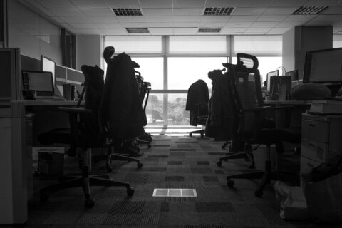 a room with a desk and chairs - Misconduct Beyond Workplace