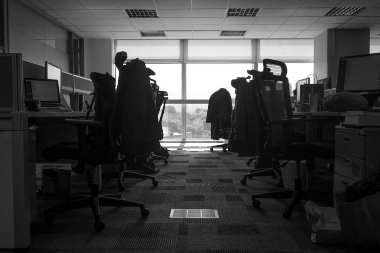 a room with a desk and chairs - Misconduct Beyond Workplace