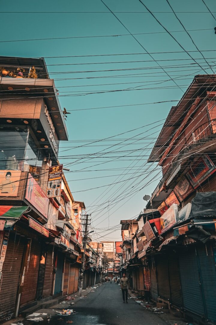 A narrow street with lots of buildings on both sides