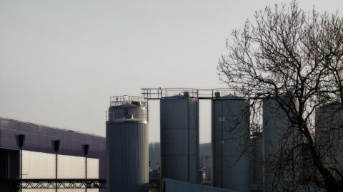 Industrial silos and buildings against a pale sky