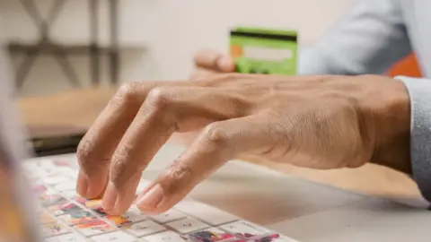 Consumer Protection (E-Commerce) (Amendment) Rules, 2026: - Person typing on a colorful laptop keyboard while holding a credi