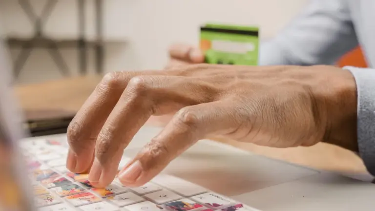 Consumer Protection (E-Commerce) (Amendment) Rules, 2026: - Person typing on a colorful laptop keyboard while holding a credi