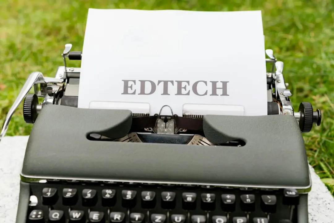 Dark Patterns in Ed-Tech: CCPA Imposes - A vintage typewriter displays 'EdTech' on paper, set outdoors on grass.