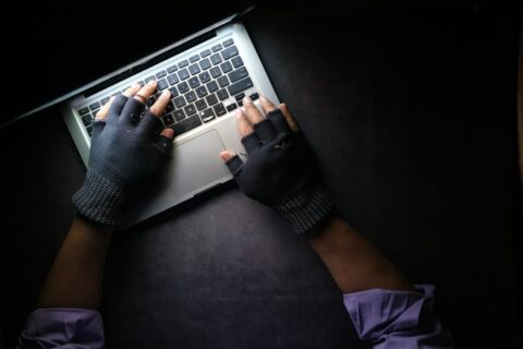 person in black long sleeve shirt using macbook pro - intermediary liability