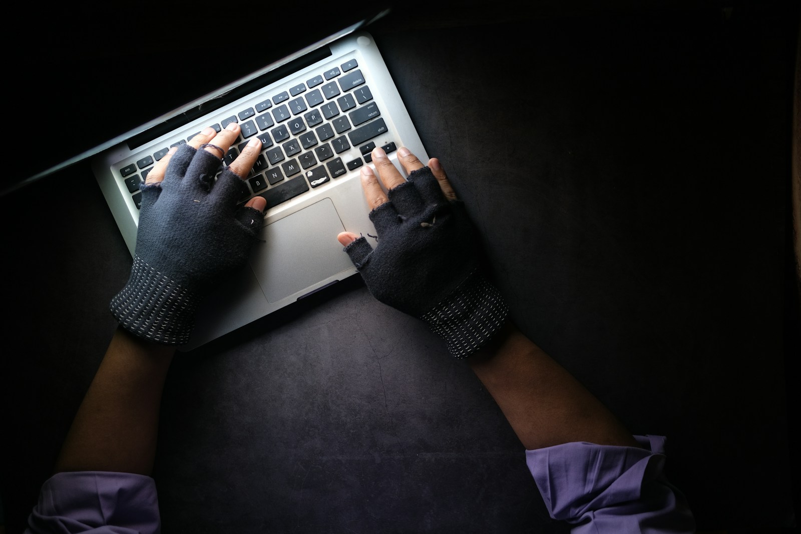 person in black long sleeve shirt using macbook pro - intermediary liability