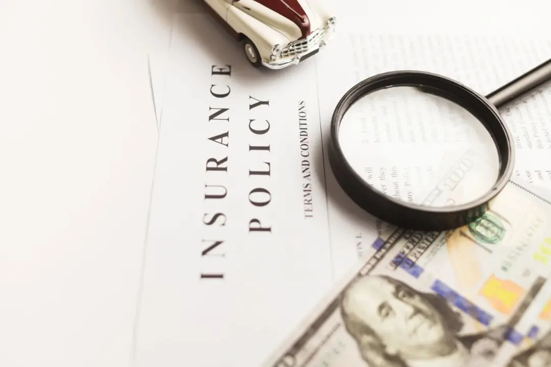 Financier’s Right to Insurance Claim: Supreme - Close-up image of an insurance policy with a magnifying glass, money, and toy