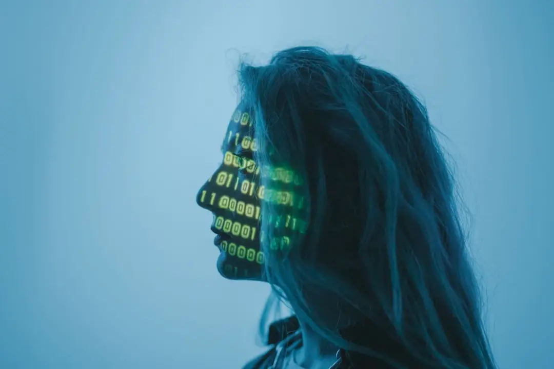 Human Primacy in the Age of - Silhouette of a woman with binary code projected on her face in a digital concept setting.