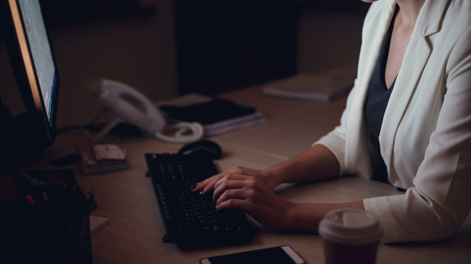 Woman working late at her office desk.