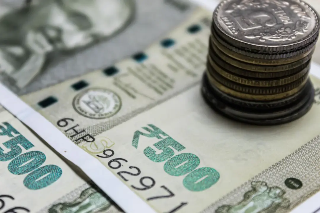 Mandatory Fresh Valuation Under Rule 8(5) - Detailed view of Indian rupees and stacked coins, representing currency and finan