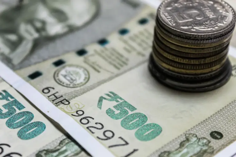 Mandatory Fresh Valuation Under Rule 8(5) - Detailed view of Indian rupees and stacked coins, representing currency and finan