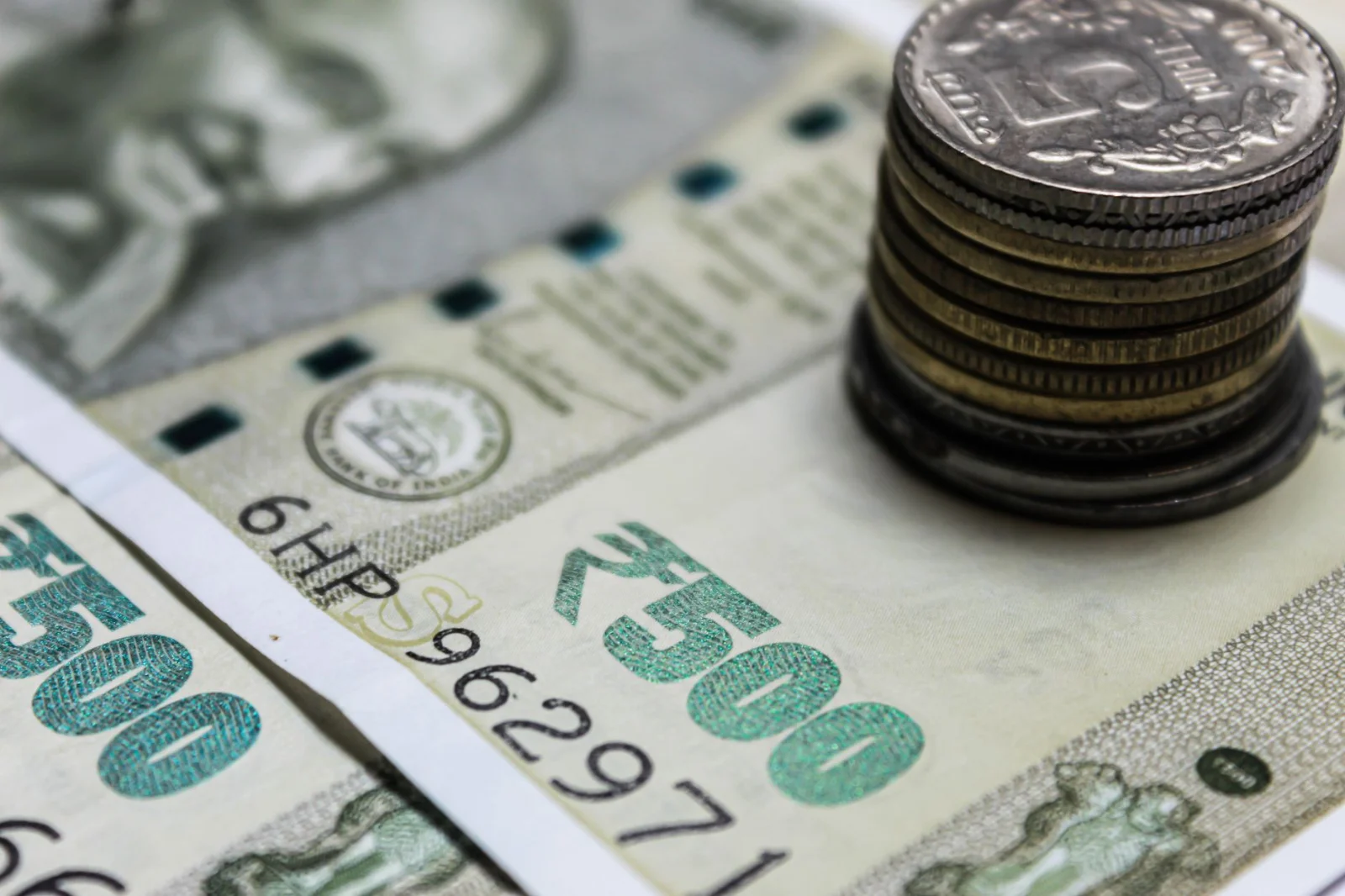 Mandatory Fresh Valuation Under Rule 8(5) - Detailed view of Indian rupees and stacked coins, representing currency and finan