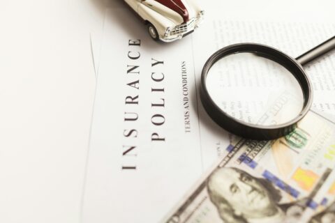 a magnifying glass sitting on top of a piece of paper - insurance policy