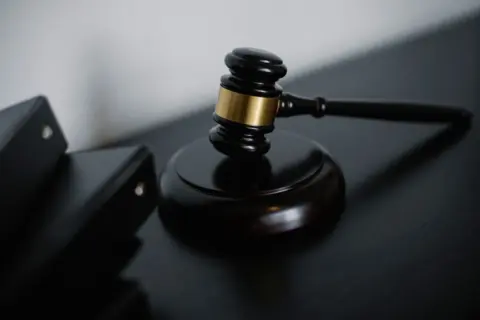 NCLAT Reaffirms: Concluded Auctions Cannot Be - High angle of shiny wooden ceremonial mallet with golden detail placed on jud