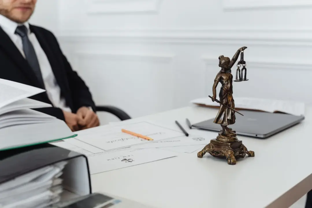 No Trade License, No Bar: Calcutta - A legal professional's workspace featuring Lady Justice statue, documents, and a laptop.