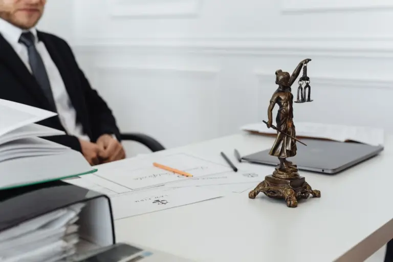 No Trade License, No Bar: Calcutta - A legal professional's workspace featuring Lady Justice statue, documents, and a laptop.