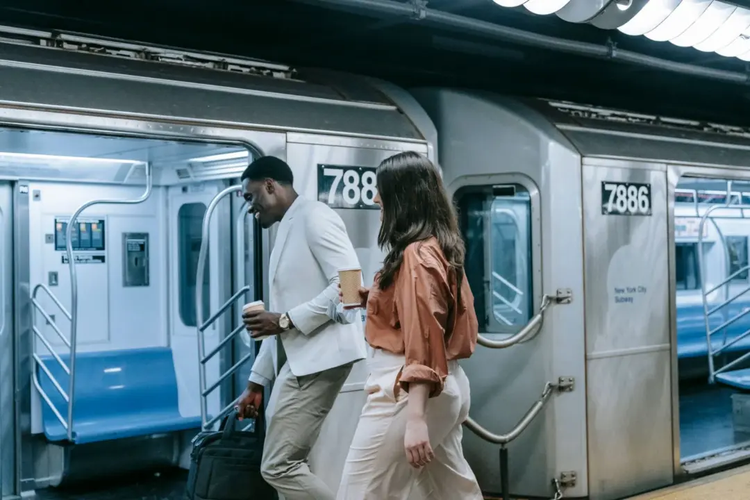 Public Transport and the Sexual Harassment - Two colleagues walking on the New York subway platform, engaging in casual conve