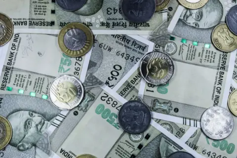 Rationalising Cross-Border Compliance: The Reserve Bank - Top view of various Indian rupee banknotes and coins, highlighting