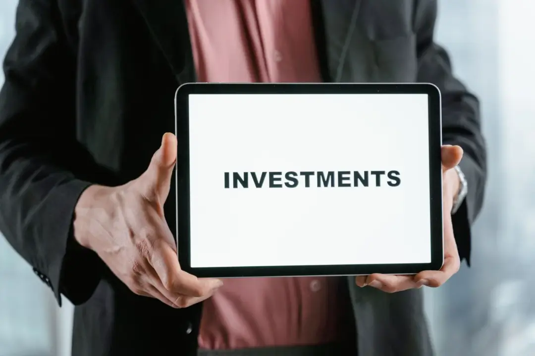 SEBI’s Strategic Shift: Balancing Professional Competence - A businessman in a suit holds a tablet displaying the text 'INVES