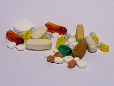 A pile of pills sitting on top of a white table - pharmacy council