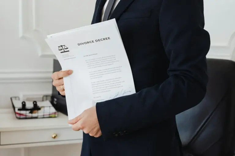interlocutory res judicata partition suit - - A person holding a divorce decree in an office setting, symbolizing legal proce
