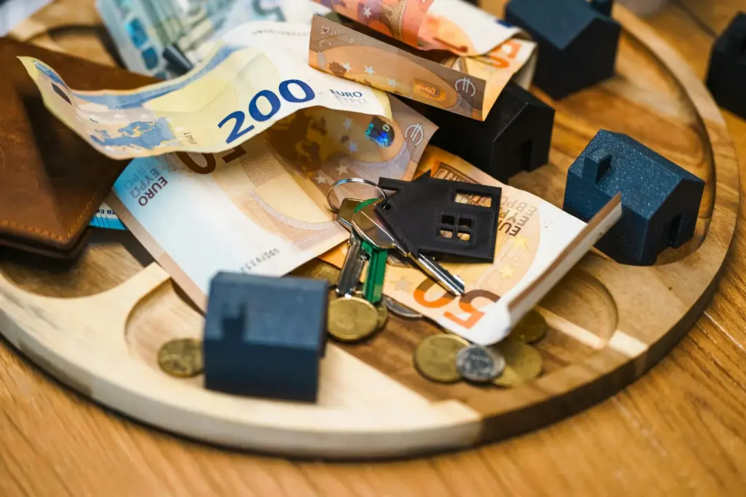 avenue realty IBC liquidation - Statutory - Euro currency, keys, and miniature houses symbolize real estate and finance conce