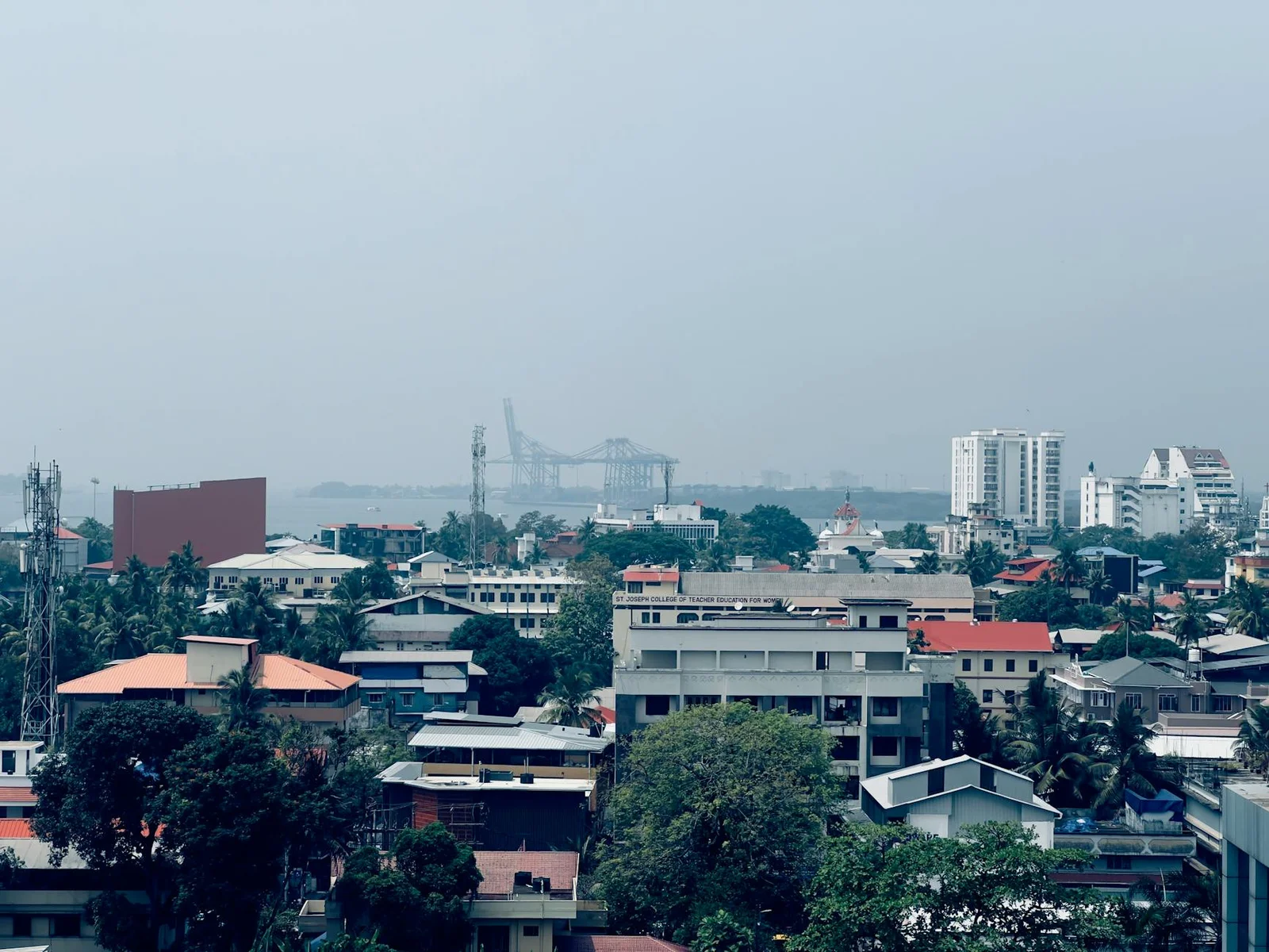 piyush kisanlal jani - The Interplay - Cityscape featuring buildings, skyscrapers, and a distant port under a clear sky.