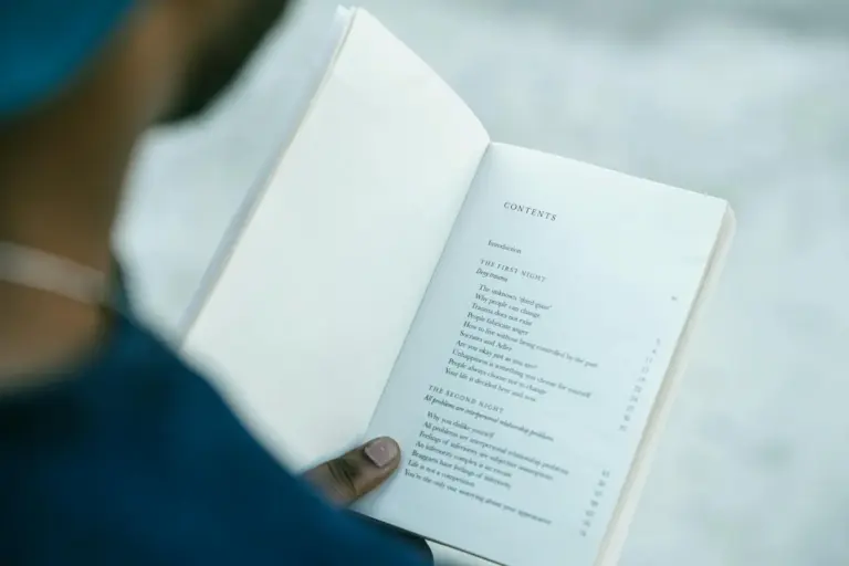 ibc moratorium commercial wisdom coc - - Close-up of hands holding an open book showing the table of contents.