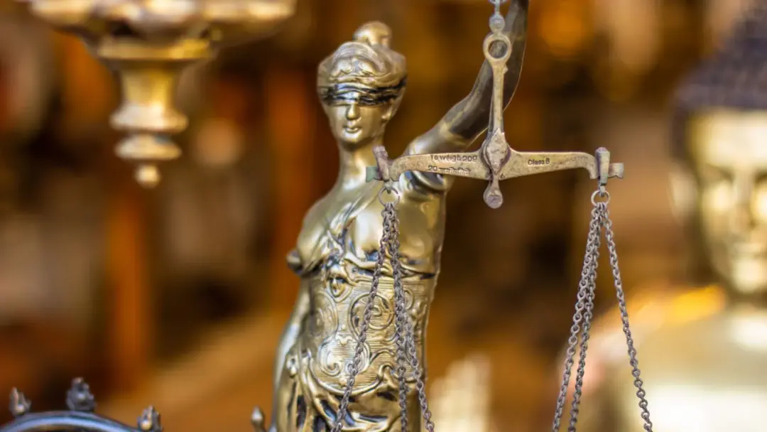 right to be forgotten indian law - A detailed close-up of a Lady Justice statue holding scales, symbolizing law and justice.