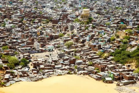 section 49 water act authorization criminal - Aerial view of a densely packed urban neighborhood with houses and greenery.