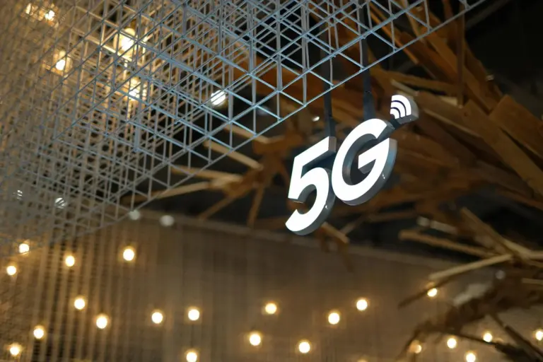 5g network slicing net neutrality india - Illuminated 5G sign with modern geometric ceiling and warm lighting.