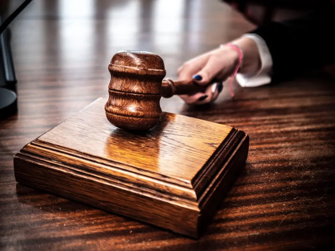 sarfaesi auction procedural lapses drt chandigarh - Close-up of a wooden gavel on a judge's desk, symbolizing justice.