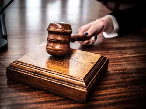 sarfaesi auction procedural lapses drt chandigarh - Close-up of a wooden gavel on a judge's desk, symbolizing justice.