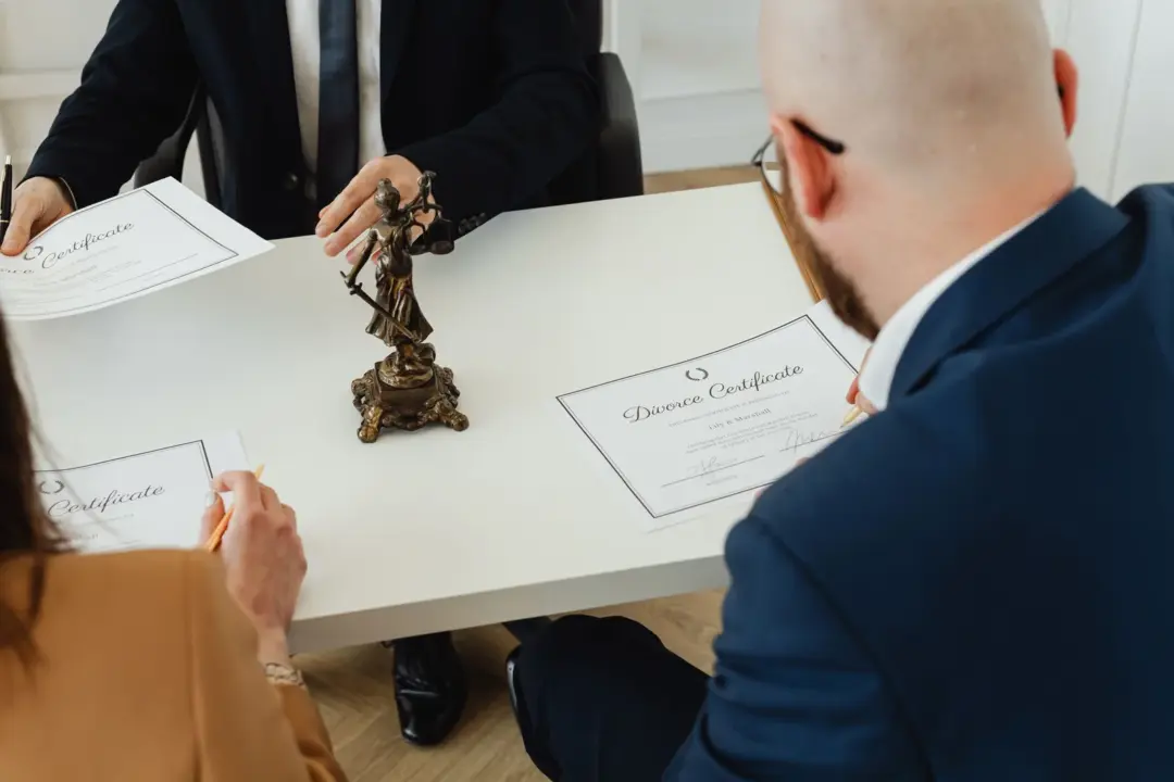 k-rera recovery certificates enforcement karnataka high - A professional setting with a focus on signing divorce documents in