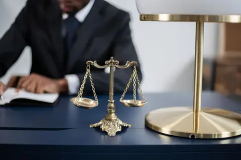 unilateral appointment of arbitrators section 12(5) - Elegant legal office with a close-up of golden scales of justice on a s
