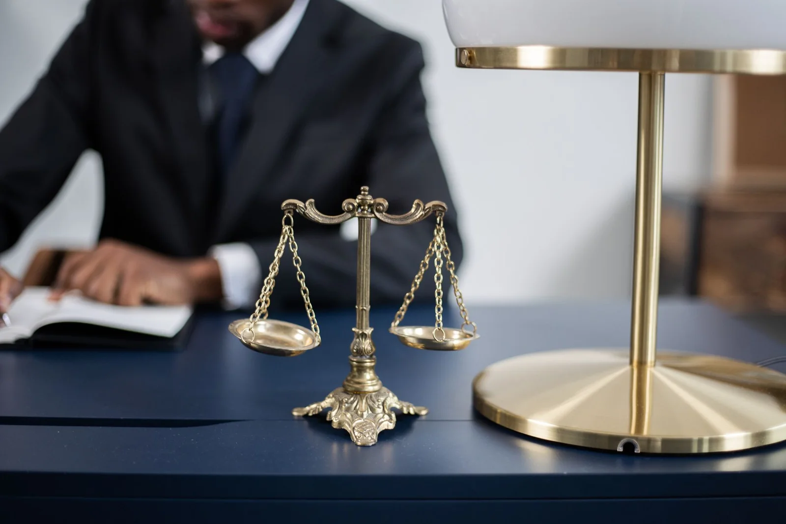 unilateral appointment of arbitrators section 12(5) - Elegant legal office with a close-up of golden scales of justice on a s
