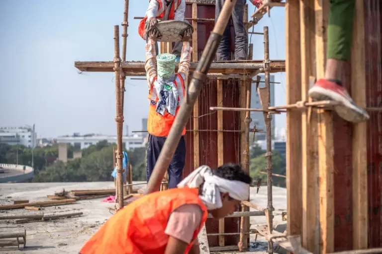 Team of construction workers building a high-rise in Delhi, India.