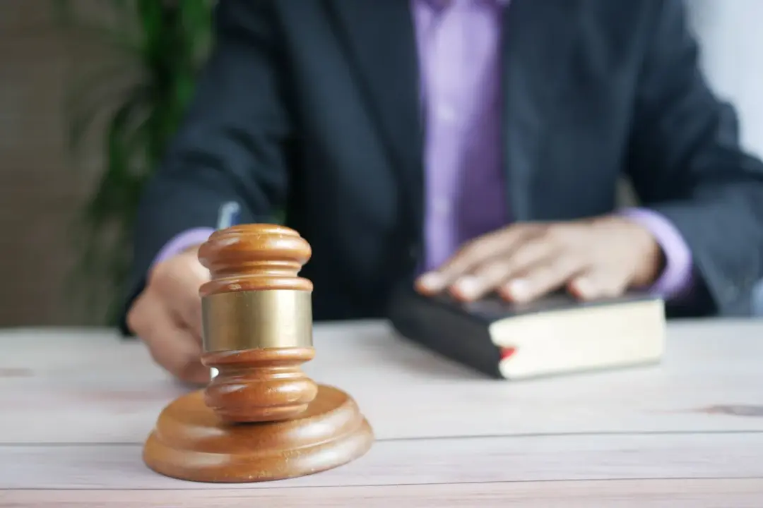 right of redemption sale notice - - A wooden gavel and legal book represent justice in a court setting, emphasizing order and