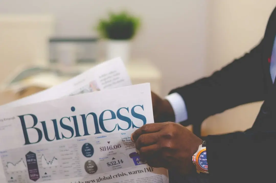EPFO claims IBC liquidation - Crystallised - Close-up of a businessman reading a newspaper indoors, focusing on business head