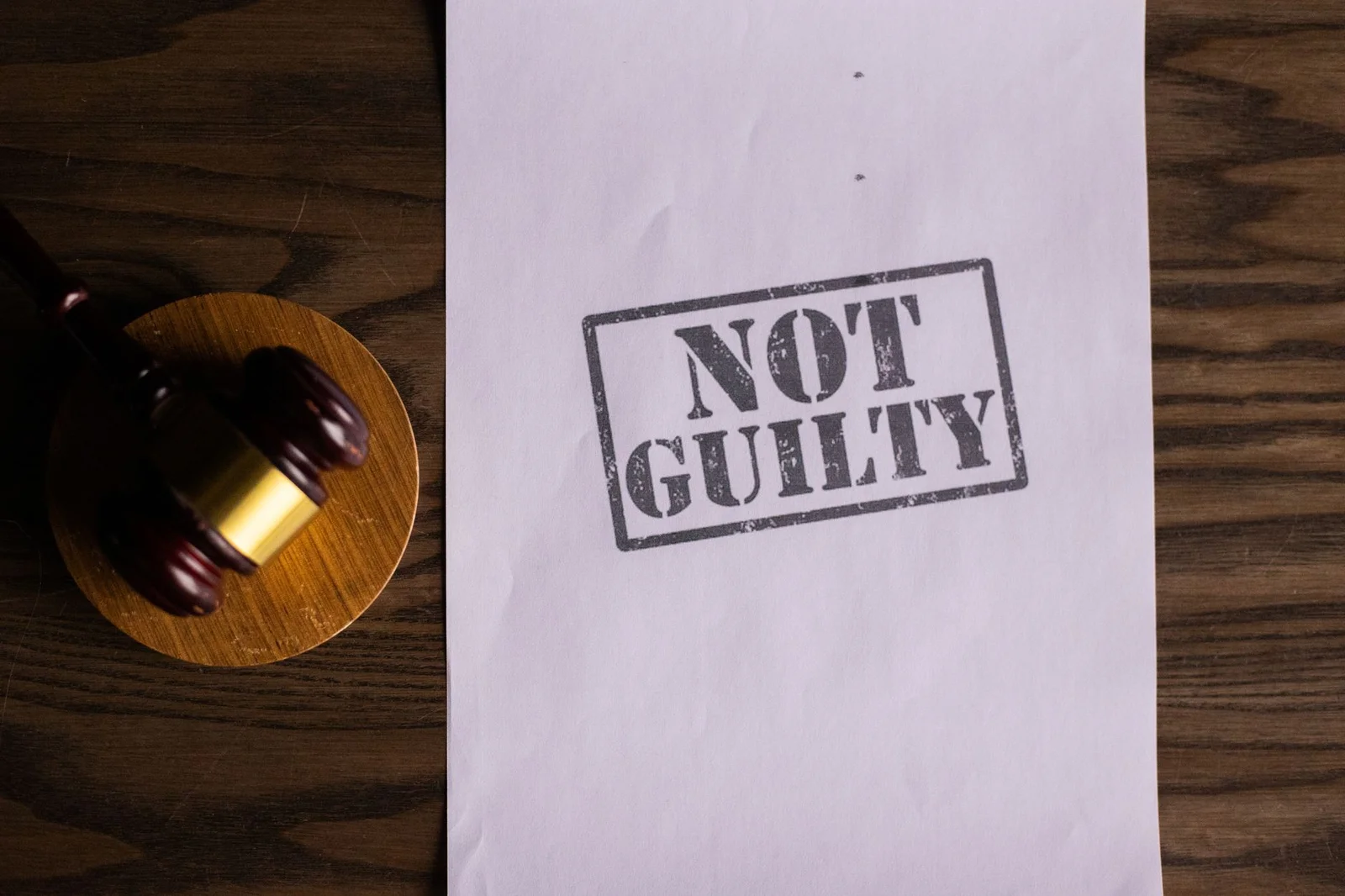 pcpndt act supreme court compliance sex - A courtroom document labeled 'Not Guilty' beside a gavel symbolizes justice.