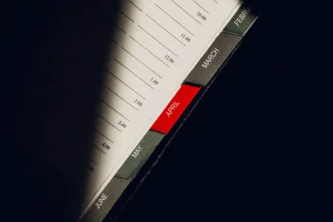 section 8 arbitration waiver - Section - A close-up shot of a planner highlighting the month of April with visible monthly ta