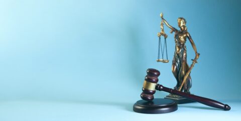 Lady justice and gavel on a blue background