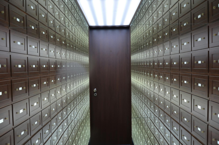 Supreme Court Reaffirms Equitable Powers Under - Wooden lockboxes line the walls of a modern, secure vault with a central woo