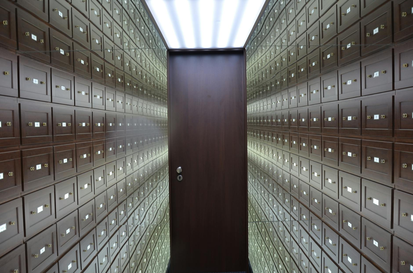 Supreme Court Reaffirms Equitable Powers Under - Wooden lockboxes line the walls of a modern, secure vault with a central woo