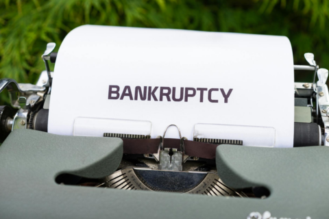 Survival of Personal Guarantors' Liability Post-Corporate - Close-up of a typewriter with the word 'BANKRUPTCY' on paper, sur