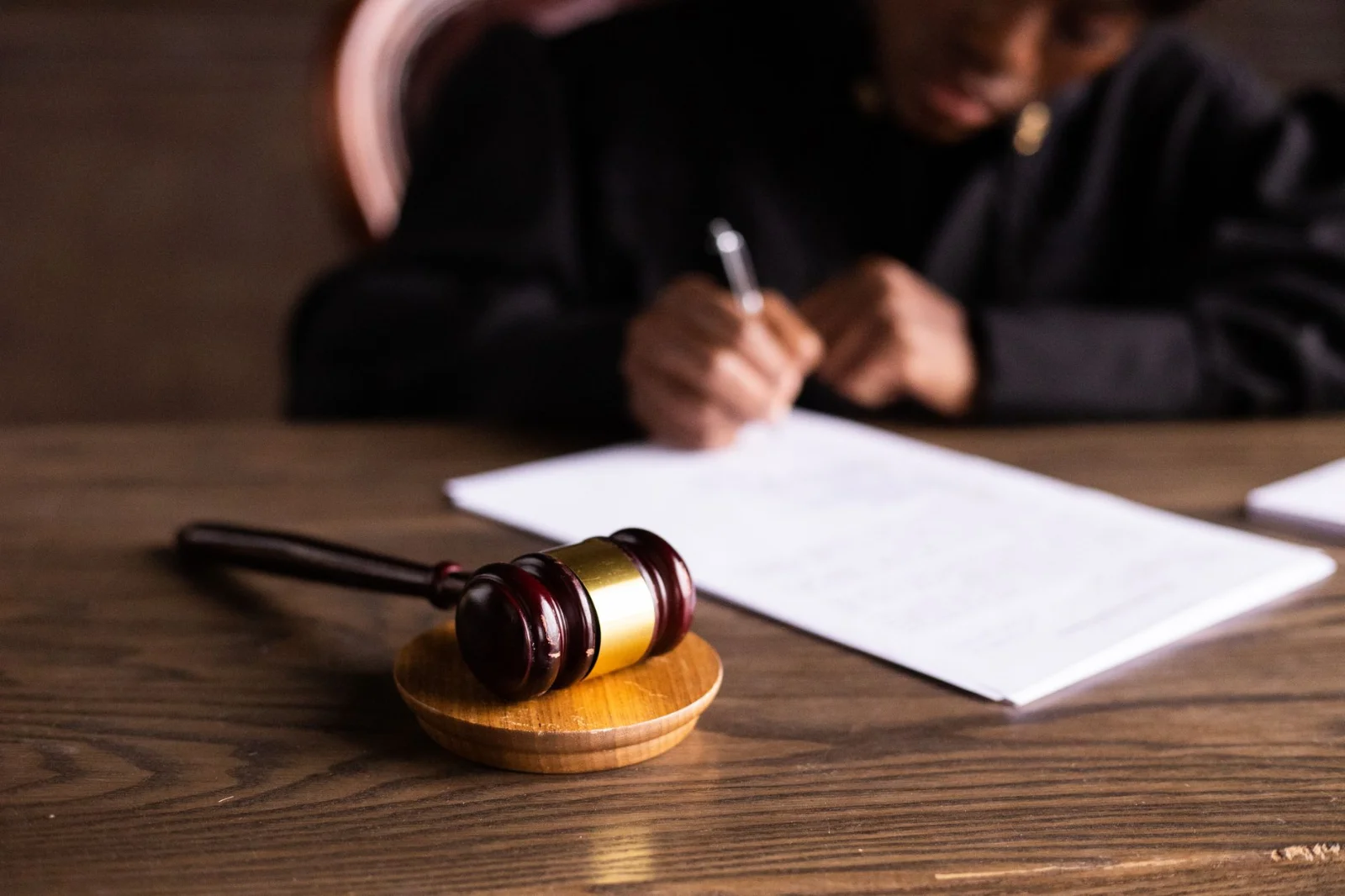 The Sole Surviving Widow’s Right to - Judge signing documents at desk with focus on gavel, representing law and justice.