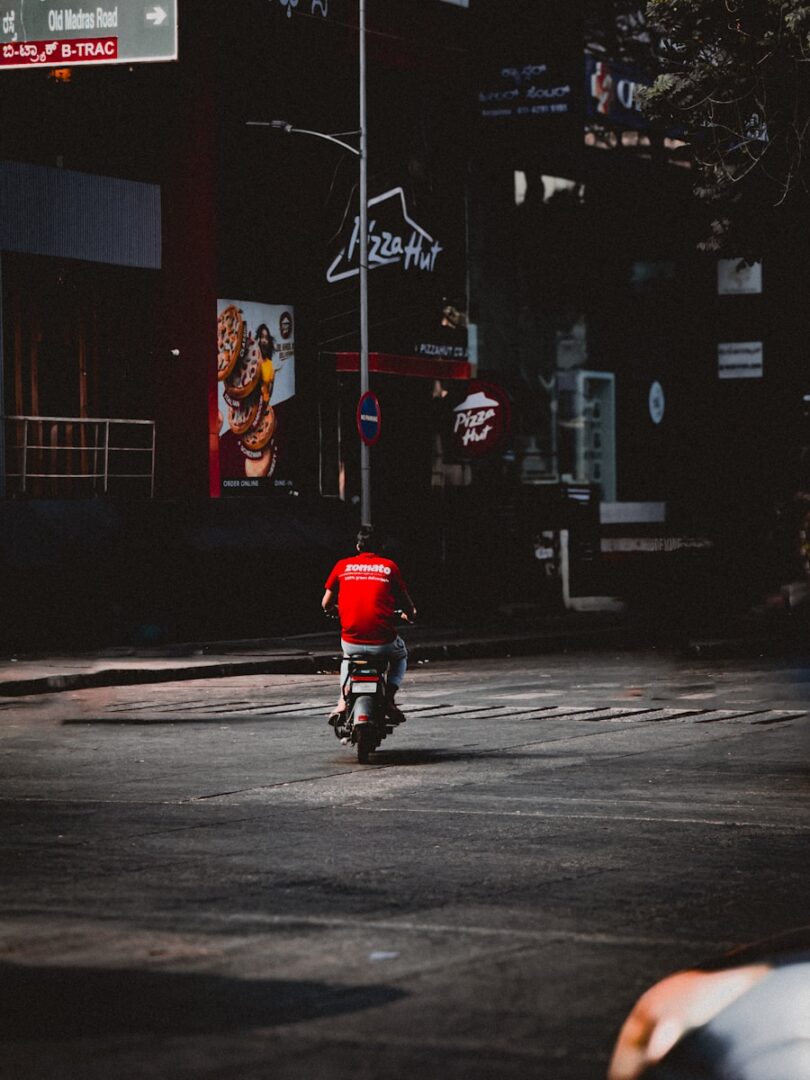 A person riding a motorcycle down a street at night