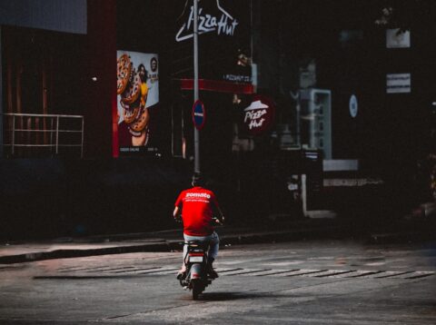 A person riding a motorcycle down a street at night