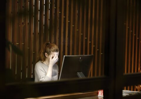 a woman sitting in front of a laptop computer - Night Work Restrictions for Women